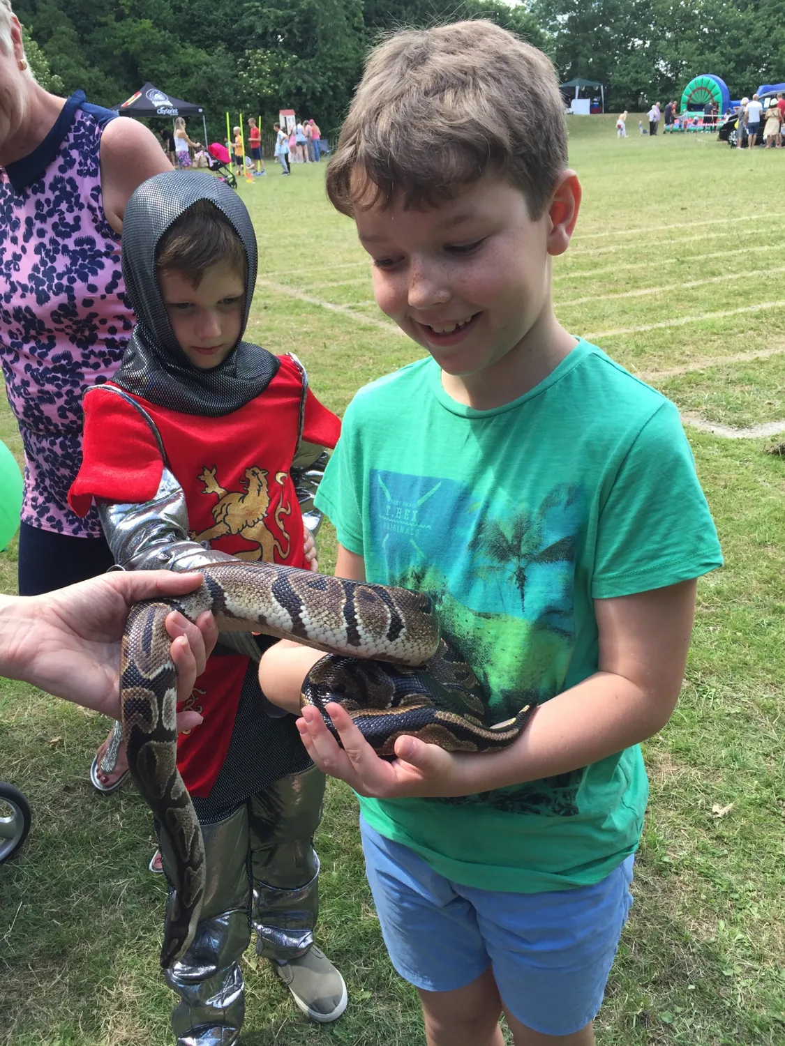 Young Cohen holding a snake at an animal event